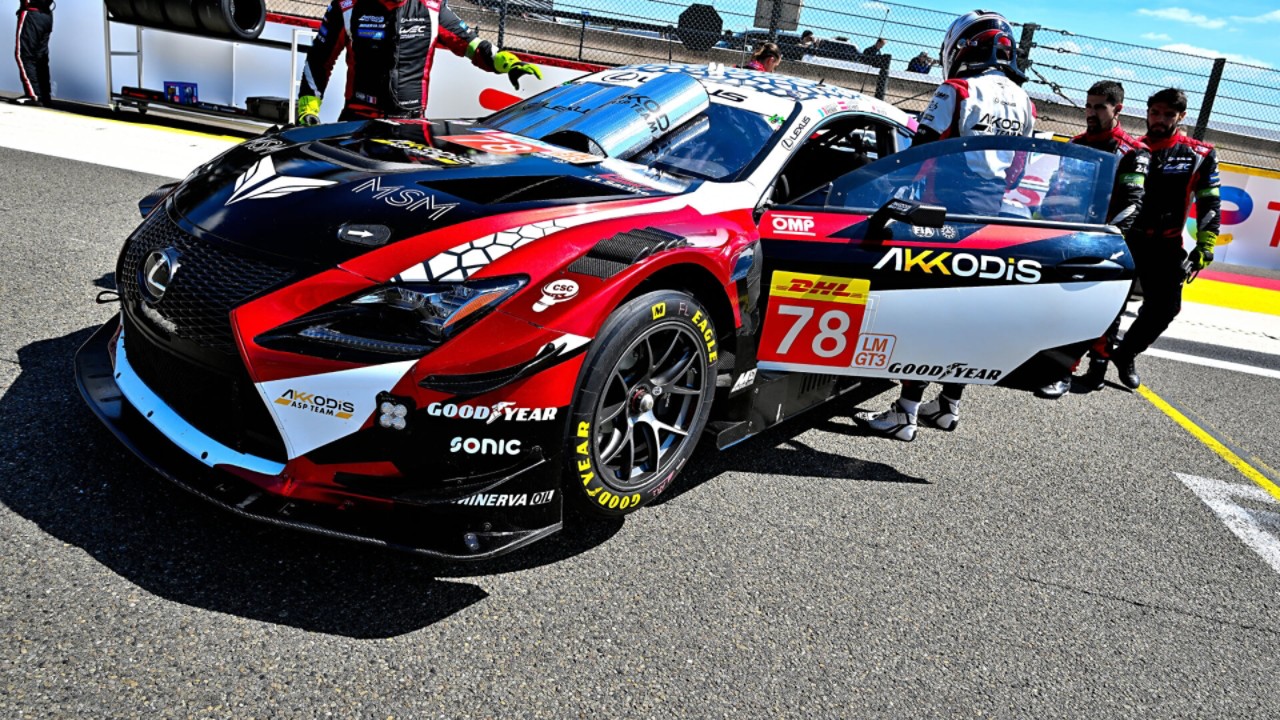 A driver and mechanics surrounding a parked Lexus RC F GT3