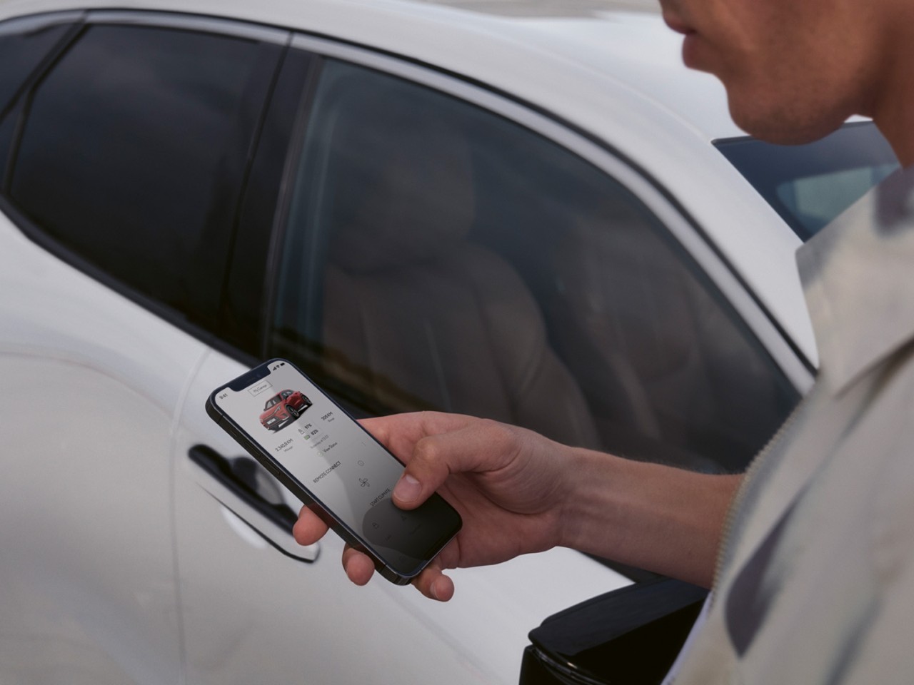 A person using a mobile phone to access the Lexus Link+ app